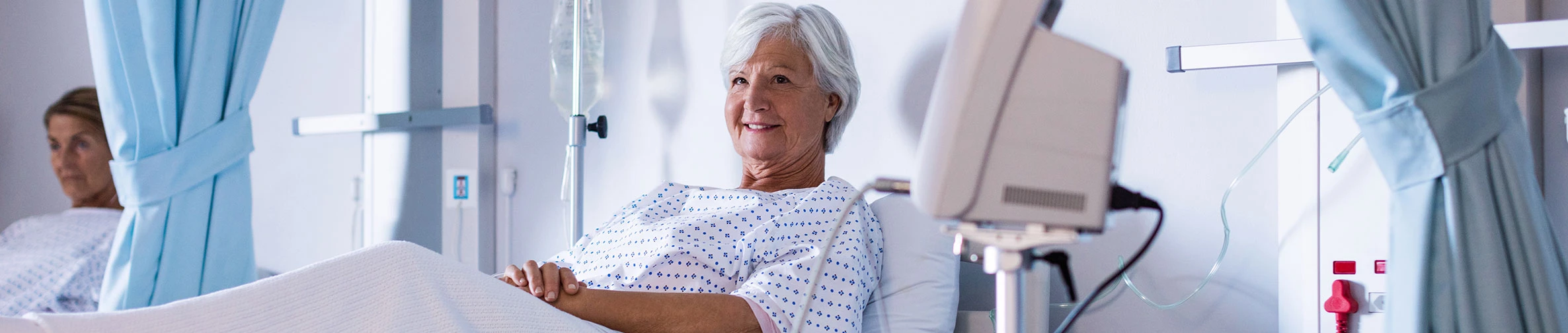 Eine ältere Patientin liegt in einem Krankernhauszimmer im Bett.